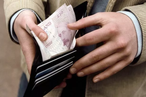 An unidentified person is counting money in their wallet. 