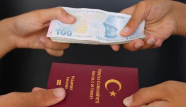 A visual representation of Türkiye’s investment citizenship route, showing hands exchanging Turkish lira and a passport, accessed on June 23, 2025. (Adobe Stock Photo)