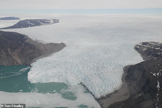 The Greenland Ice Sheet (pictured) is the second biggest body of ice in the world and covers almost 80 per cent of Greenland's surface. Experts believe the black iceberg could have originated from Greenland