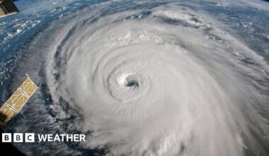 photo of a swirl of white, with an eye in the middle, showing hurricane Florence from space