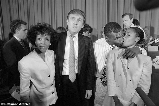 Tyson tries to kiss then-wife Robin Givens as her mother stands with Donald Trump in 1988