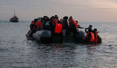 A boy is lifted onto a migrant dinghy as a French rescue vessel watches on, on May 31, 2025 in Gravelines, France
