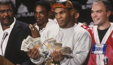 Standing alongside promoter Don King, Tyson flashes some cash to the media