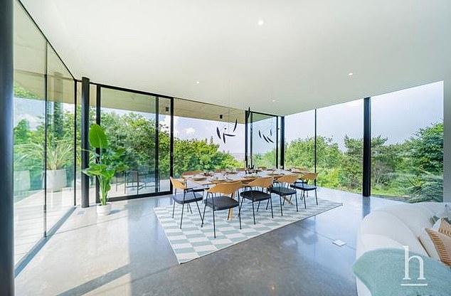 This huge wooden dining table provides panoramic views of the surrounding coastline