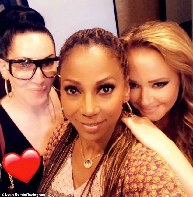 Remini talks to her current BFF Michelle Visage (L, pictured in 2021) 'on FaceTime for an hour every morning' and she's on a funny 'text chain' with Holly Robinson (M) and Tisha Campbell