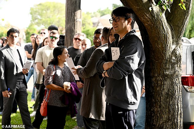 PropTrack estimated Sydney's median house would cost $338,000 today, or just 4.3 times the average salary now for all Australian workers, if house prices had increased at the same pace as wages during the past 45 years (pictured is an auction at Homebush in the city's west)