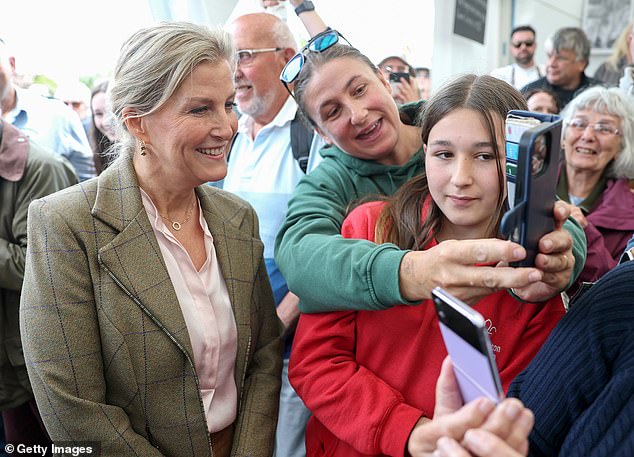 Say cheese! The Duchess posing for selfies with royal fans at the agricultural event in Cornwall