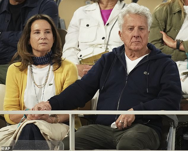 The lovebirds held hands during the game