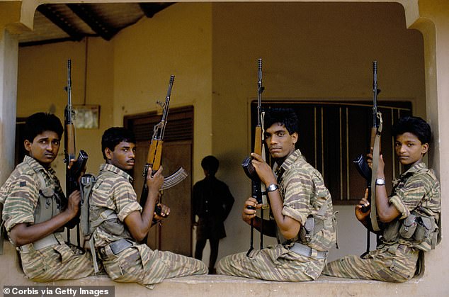 An asylum seeker who allegedly recruited child soldiers for the Tamil Tigers terrorist group has won an appeal (pictured: Tamil Tigers fighters in a stock photo)