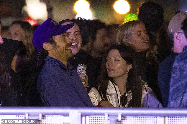 Harry was in great spirits as he laughed and chatted with a large group of pals whilst waiting for the set to start