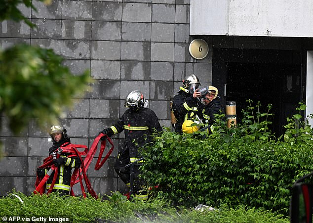 Firefighters at the apartment building in Reims, which was described as being like 'a war zone'