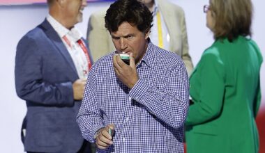 Political commentator Tucker Carlson holds a pack of nicotine pouches at the Republican National Convention in Wisconsin