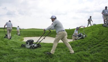 The rough at Oakmont Country Club is trimmed by employees pushing around lawn mowers