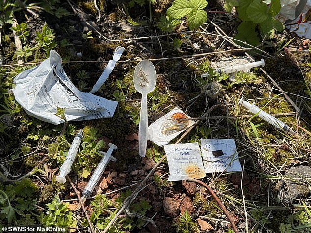 In the streets surrounding the park countless used syringes and discarded plastic spoons, stained with the dried-up gunk from heroin, are scattered across the ground