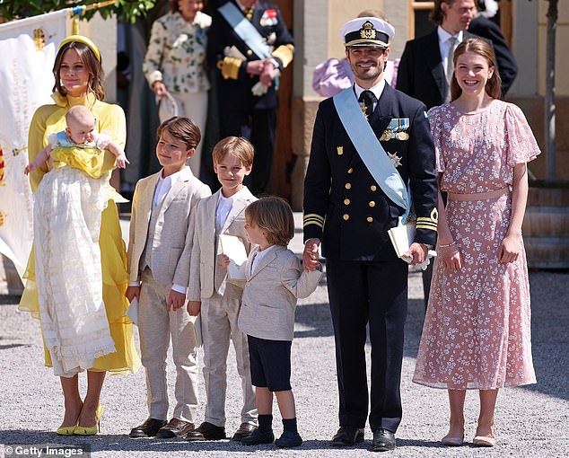 Her 46-year-old husband appeared charming in his military uniform. The parents-of-four were also joined at the christening by their sons, who looked adorable in matching white shirts and cream blazers. The family pictured alongside Princess Estelle