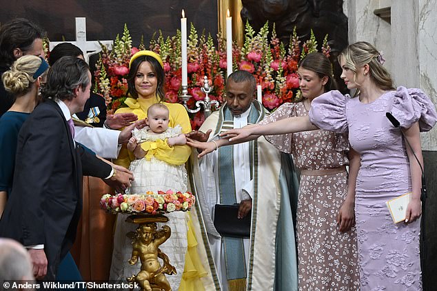 Princess Sofia with her daughter  and on the right pastor Michael Bjerkhagen together with godparents Claes Kockum, Sandrine Kockum, Fredrik von der Esch, Princess Estelle and Tiara Larsson during Princess Ines' baptism