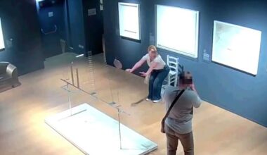 As the man takes the woman's photo, she leans in front of the the chair in order to create the illusion in the photograph that she is sitting on it