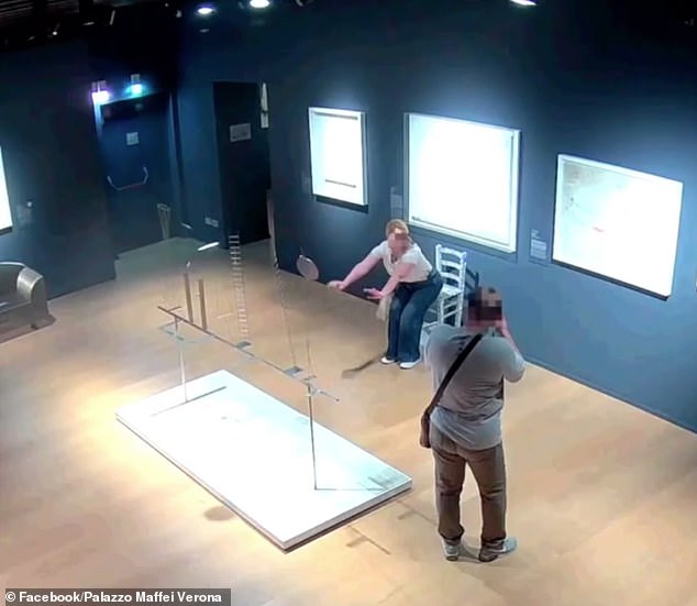 As the man takes the woman's photo, she leans in front of the the chair in order to create the illusion in the photograph that she is sitting on it