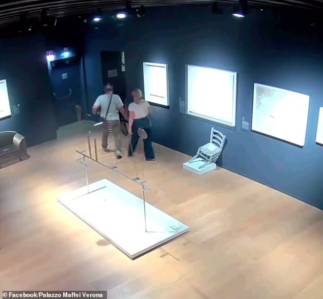 The crystal-studded art is is left in a crooked state as the pair scurry out of the room