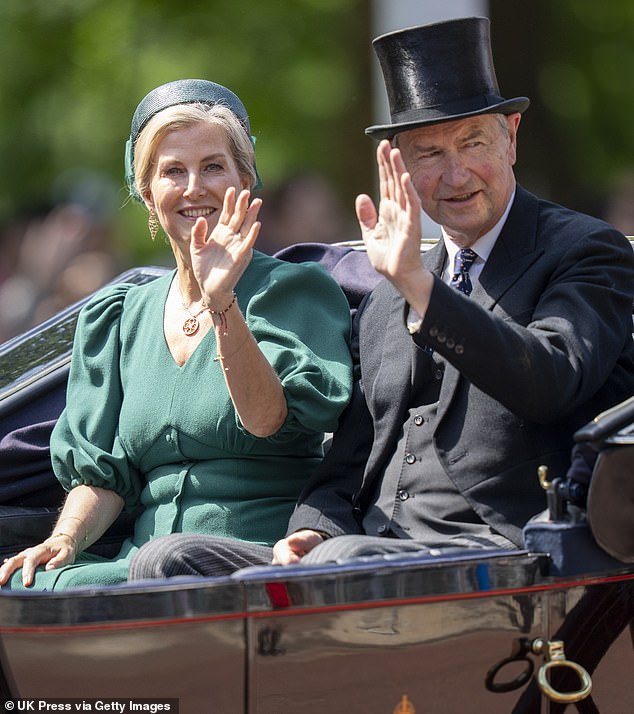 Sophie, Duchess of Edinburgh and Timothy Laurence smile and wave at the adoring crowds