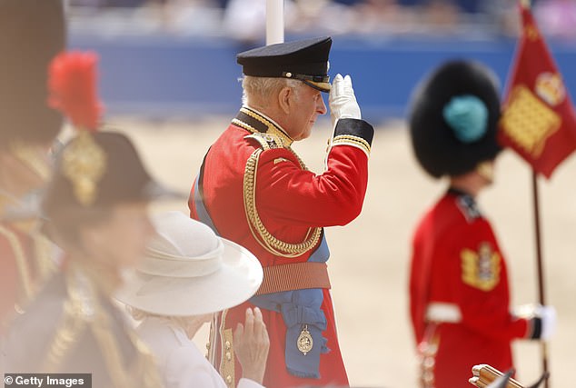 King Charles III salutes his soldiers at the parade ground during the Trooping the Colour