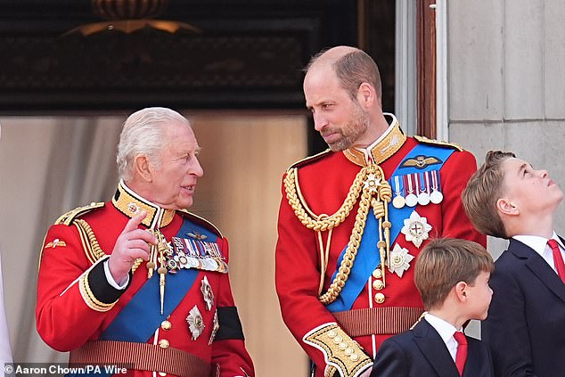 The King and his son have a conversation on the balcony at Buckingham Palace