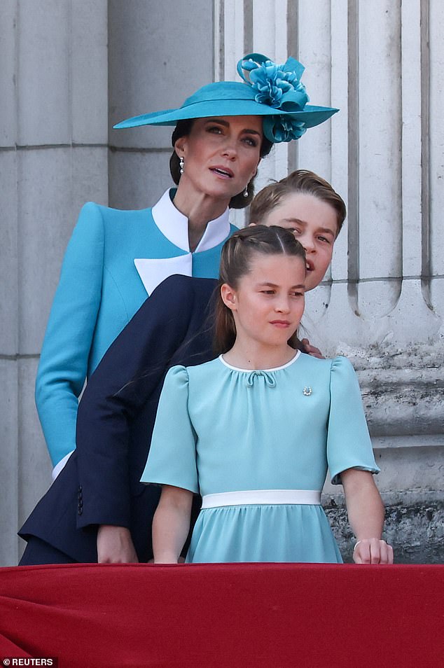 The Princess of Wales, Prince George and Princess Charlotte strain to get a better view of the aircraft during their balcony appearance