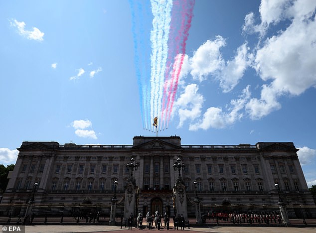 The Royal Family stand on the Buckingham Palace balcony during the fly past by the Red Arrows