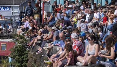 Sunbathers pictured sitting on a wall at Bristol Harbourside on Sunday. Parts of the UK will bask in 24C heat today as the balmy summer conditions continue