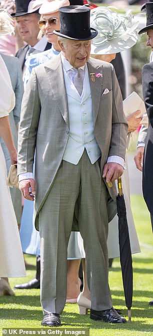 King Charles wore a smart top hat and carried a black umbrella