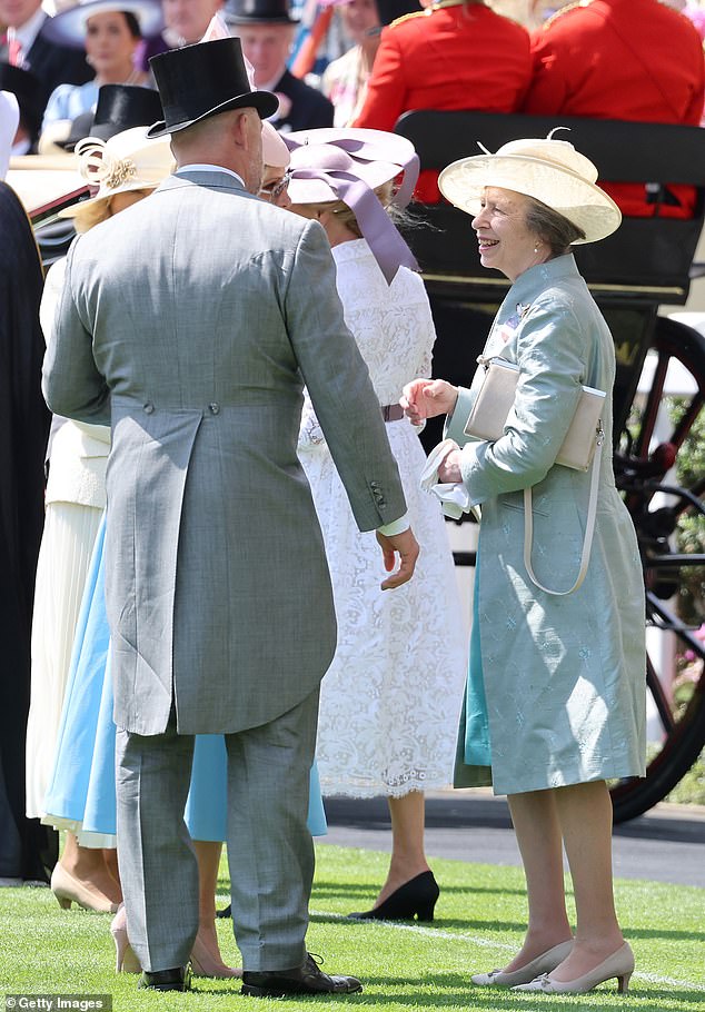 The Princess Royal rewore her Shibumi 'Lrya' Coat in turquoise. Pictured chatting to her son in law, Mike Tindall
