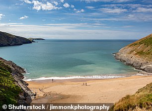Traeth Mwnt on the west coast of Wales is known for its white sand and scenic coastal paths.