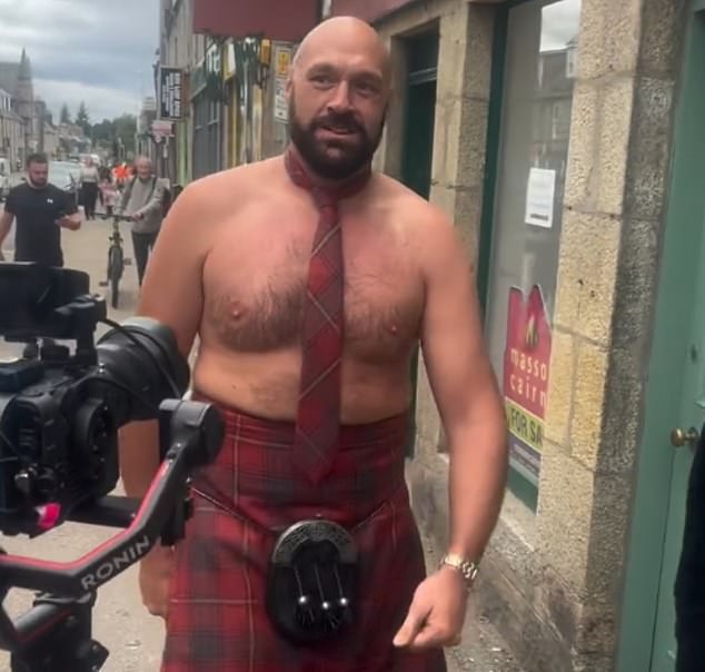 Tyson Fury has been spotted marching around a Scottish town topless and wearing a kilt