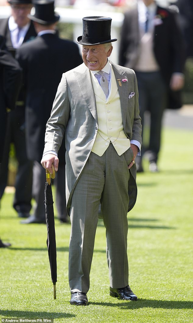King Charles, dressed in a top hat and carrying an umbrella, will no doubt be looking forward to another day at the races