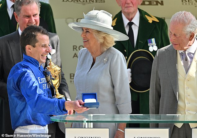 Queen Camilla and King Charles III on stage to present the winner of the Gold Cup to Jockey William Buick