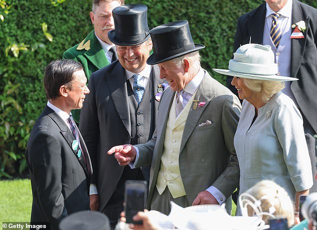 King Charles III and Queen Camilla share a joke with Frankie Dettori (L)