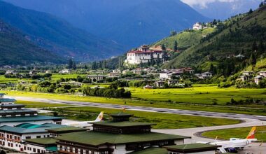 Paro Airport , in Bhutan, is completely surrounded by the Himalayas and, when landing, planes have to dive through narrow valleys with no radar