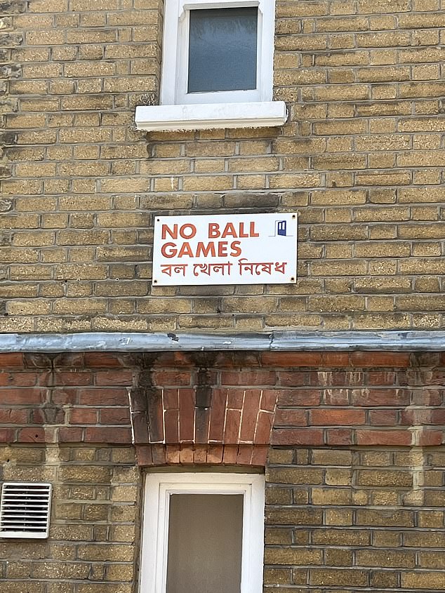 Street signs warning of 'No ball games' are written in Bengali as well as English