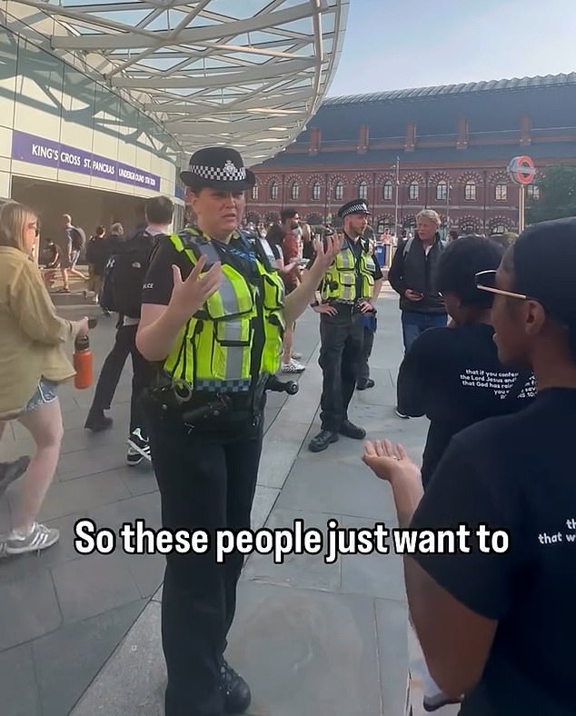 The short clip from the bizarre confrontation sees the woman cop telling the evangelists 'it's so loud'