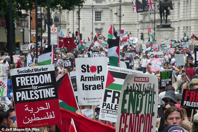 Several signs calling for Israel to not be armed and for freedom in Palestine during a protest in central London today