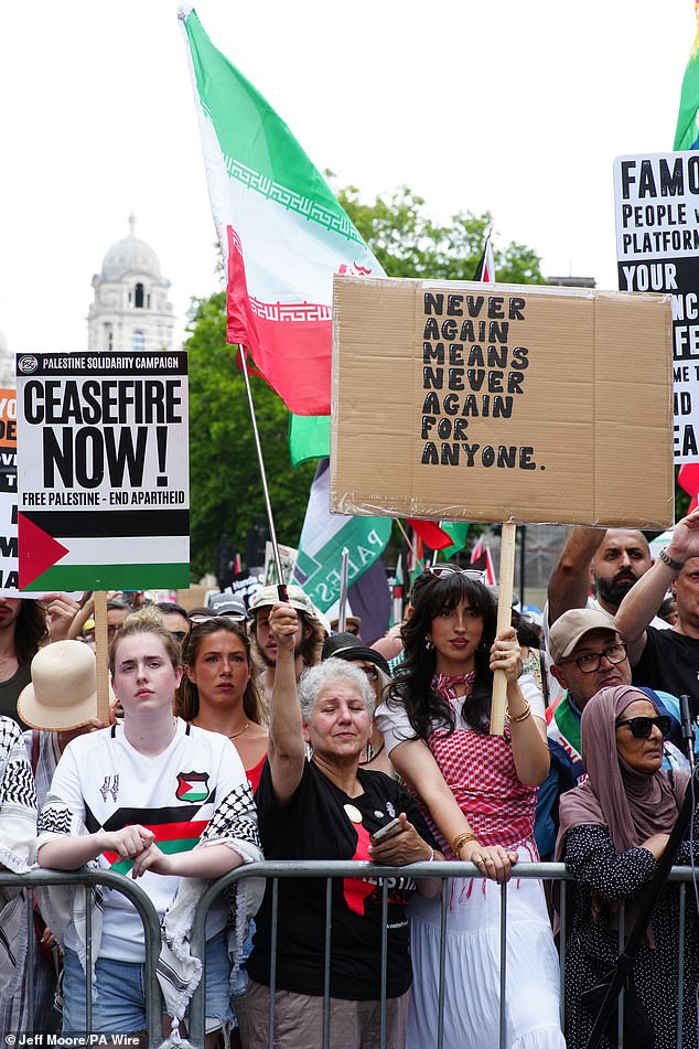 People listening to speakers in Whitehall after a march organised by the Palestine Solidarity Campaign, from Russell Square to Whitehall in central London