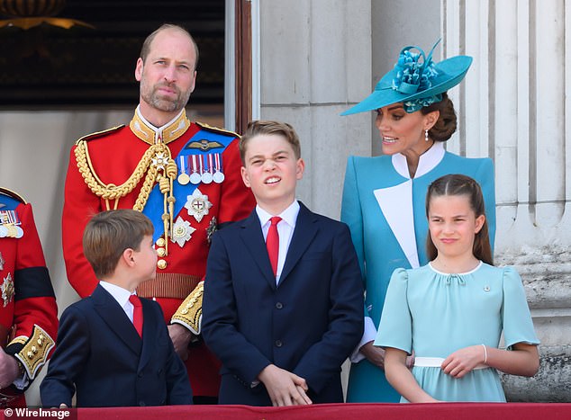 Prince George (central) stands between Prince Louis (left) and Princess Catherine (right) on the balcony at Buckingham Palace, while their parents the Prince and Princess look on