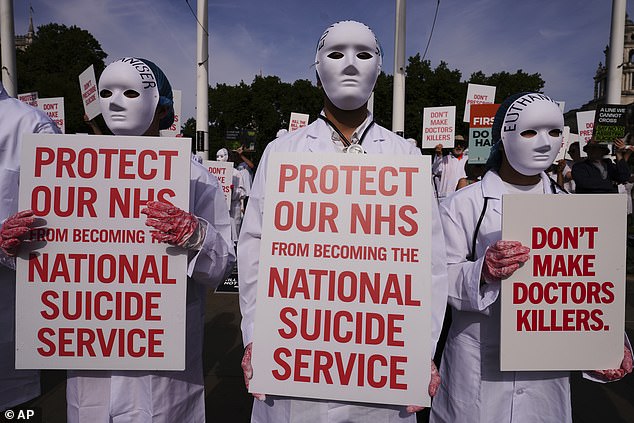 On Friday MPs narrowly voted the Bill through by 23 votes – 32 fewer than when they backed it in principle in November. Pictured: Demonstrators against assisted dying outside Parliament