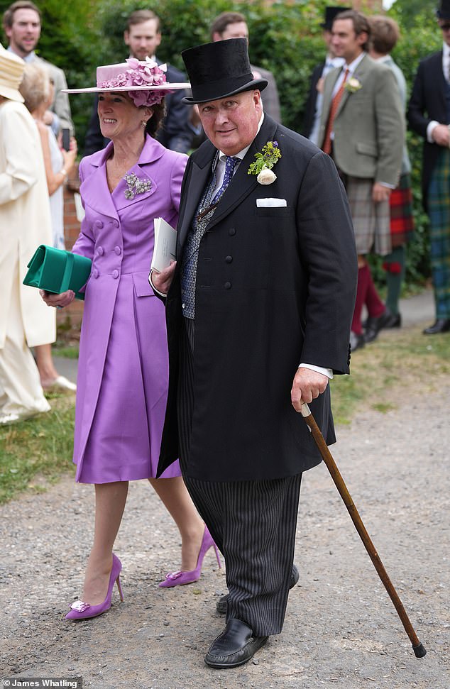 Diana Lindesay-Bethune, Countess of Lindsay and mother of the groom, and father-of-the-bride David Manners, 11th Duke of Rutland, stride together to the church ceremony