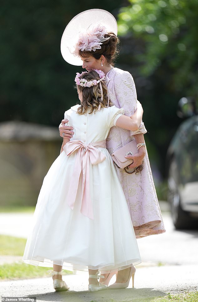 A hug for the flower girl, Emma Manners appeared to be enjoying her role as mother-of-the-bride