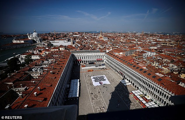 A team of former US marines has already been hired to provide security for the event by Bezos, which is due to take place over three days from June 26 in the iconic lagoon city. Pictured: A banner against Bezos lies on the ground in St. Mark's Square