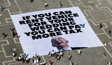 Amazon boss Jeff Bezos and bride to be Lauren Sanchez 's have been forced to change one of the venues for their £36million Venice wedding because of 'rising global tensions' it was claimed today. Pictured: A large banner against Amazon founder Jeff Bezos lies on the ground