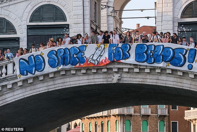 Bezos and Sanchez nuptials has already attracted huge controversy with protests planned by locals angry at the couple for 'taking over the city' for the planned three day festivities. Pictured: Protesters display a banner reading 'No Space for Bezos!' on the Rialto Bridge