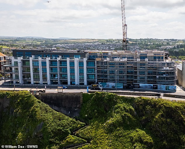 Residents of the cluster of luxury cliffside apartments were marketed 'high-end' coastal living spaces, offering a 'special and rare' opportunity