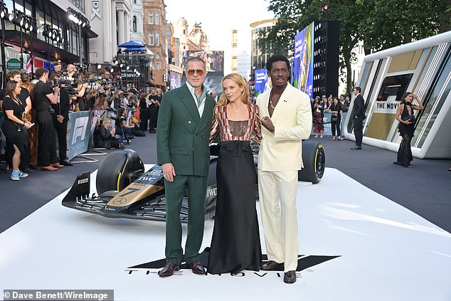Brad Pitt, Kerry Condon and Damson Idris pose together for snaps on the red carpet beside a F1 car